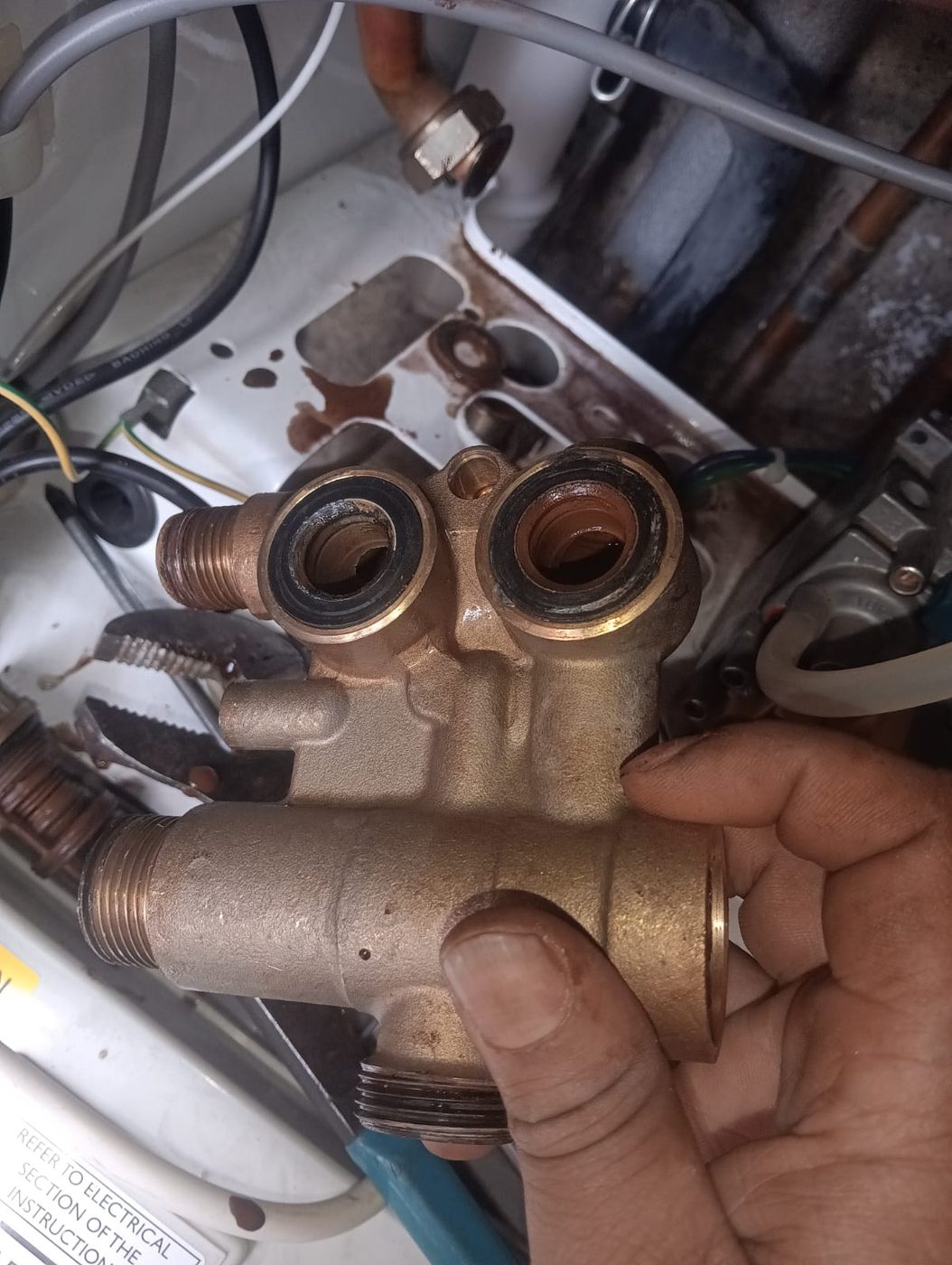 Gas Safe engineer replacing a leaking diverter valve on a Baxi boiler in Elm Park, East London