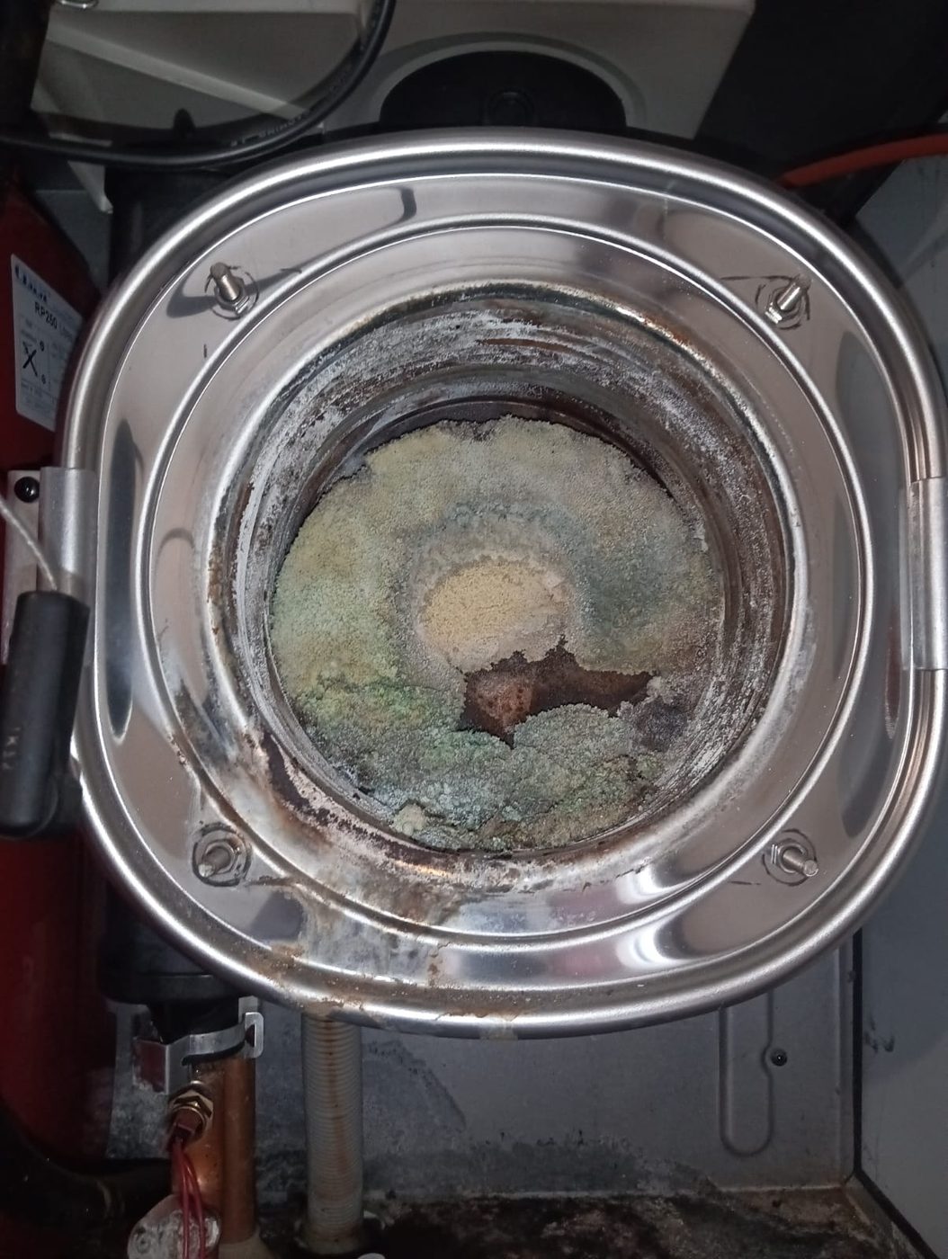 Corroded, leaking heat exchanger from a condemned Potterton boiler replaced with a new Vaillant in Elm Park, East London