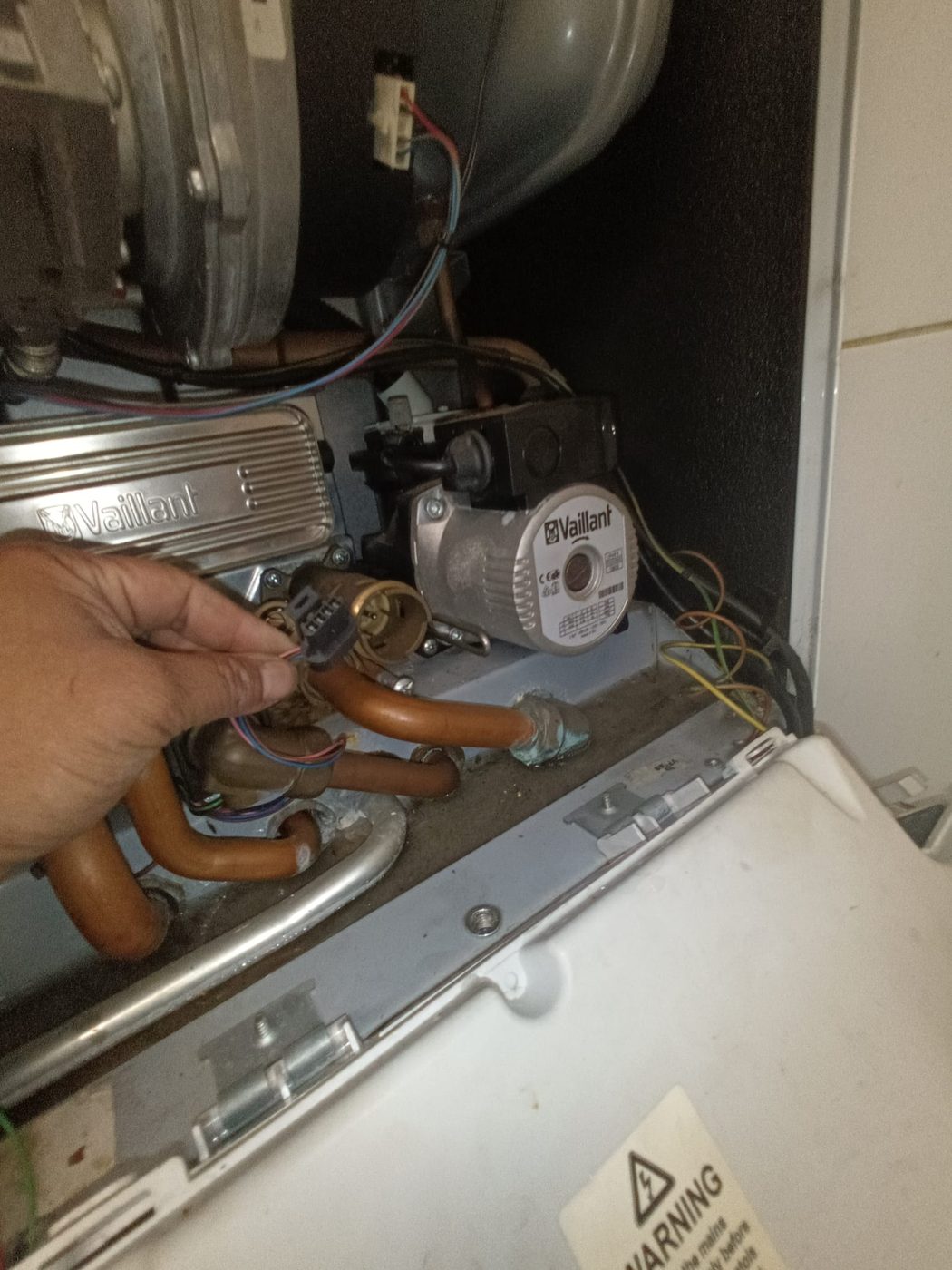 Gas Safe engineer replacing a faulty diverter valve motor on a Vaillant boiler in Barking, East London